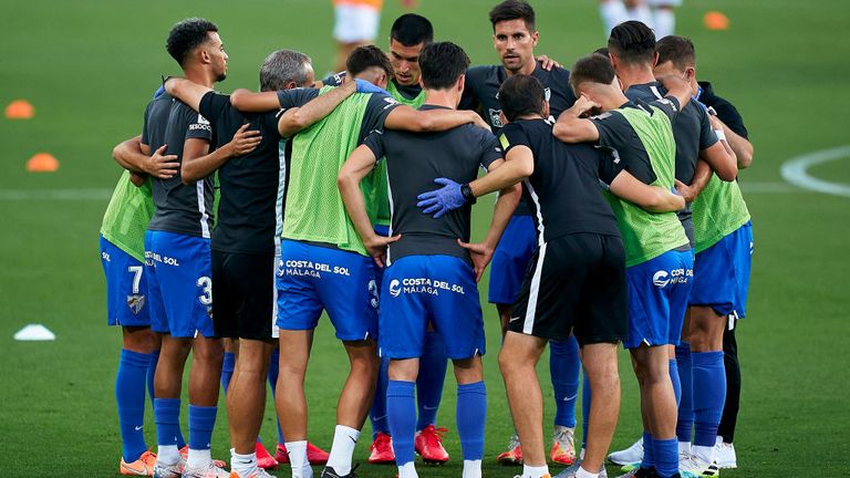 Players of Malaga during the warm-up prior to their match against Extremadura UD in June