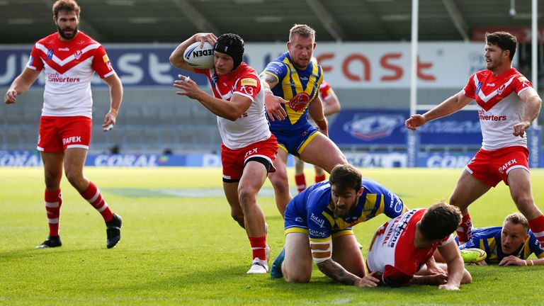  St Helens' Jonny Lomax breaks through to score their first try