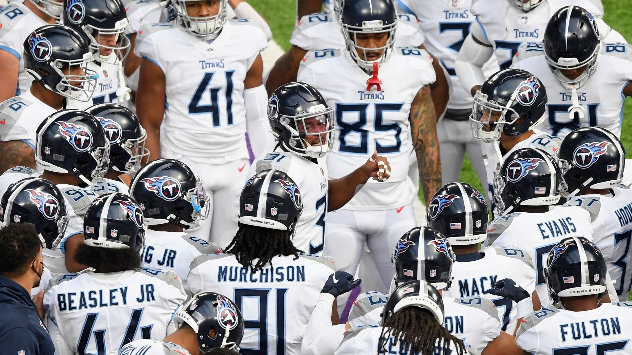 A Tennessee Titans player warms up near a Salute to Service military  appreciation banner before an NFL football game between the Titans and the Chicago  Bears Sunday, Nov. 8, 2020, in Nashville