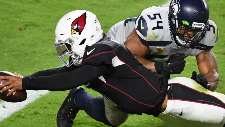 Kyler Murray dives in at the goal line as he scores on a rushing TD to go with his three passing strikes