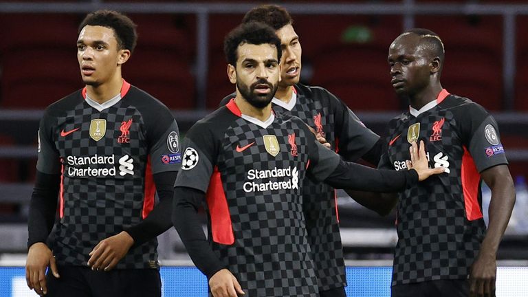 Liverpool players celebrate after Sadio Mane's effort was turned into his own net by Nicolas Tagliafico