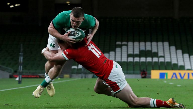 Andrew Conway is tackled by Josh Adams