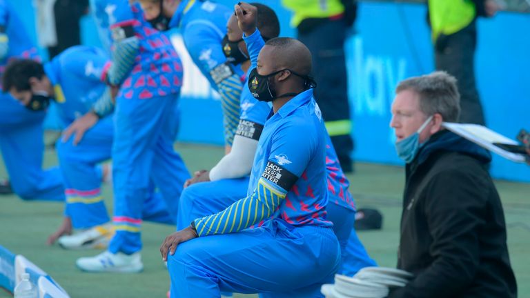 South African players and officials kneel in solidarity with the global Black Lives Matter movement ahead of the 3TC Solidarity Cup cricket match