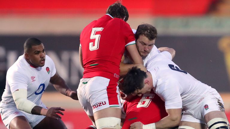 England's Joe Launchbury is held in a tackle