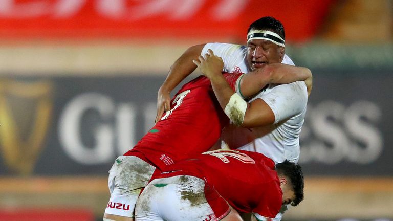 Mako Vunipola of England is tackled by James Botham and Johnny Williams 