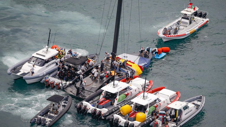 American Magic's race boat PATRIOT had to be helped in the water