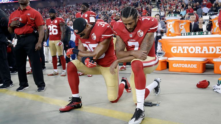 San Francisco quarterback Colin Kaepernick (right) kneels during the national anthem in September 2016