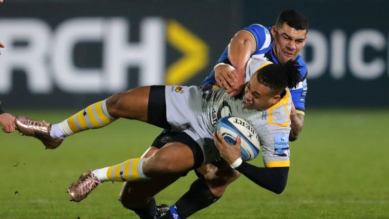 Wasps' Marcus Watson is tackled by Bath Rugby's Josh Matavesi 