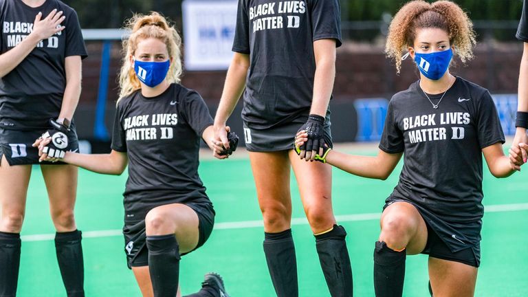 Darcy Bourne and her Duke team-mates take part in a gesture of solidarity