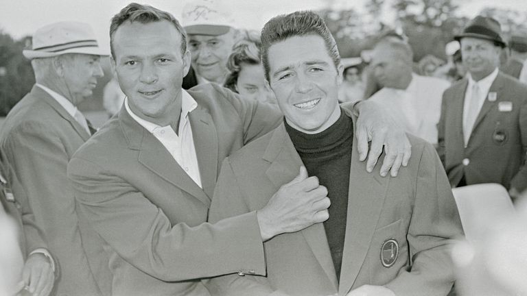Arnold Palmer (left) helps Player with the Green Jacket after his victory in the 1961 Masters