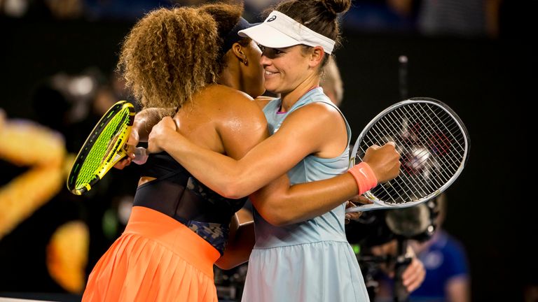 Osaka (left) and Brady embrace at the net