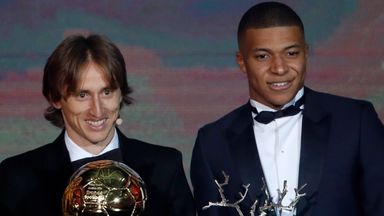Image of Luka Modric and Kylian Mbappe pictured with the Ballon d'Or and Kopa Trophy in 2018