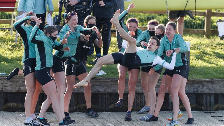 Cambridge women celebrate by throwing their cox Dylan Whitaker in the river