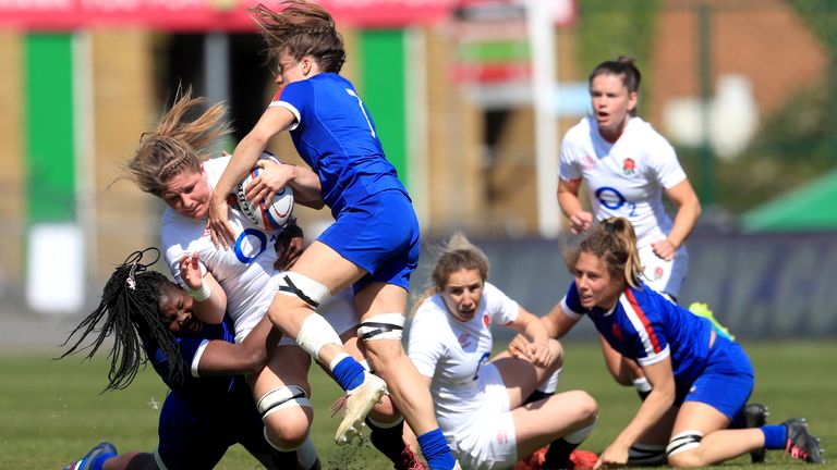 England's Poppy Cleall is tackled by France's Madoussou Fall (left) 