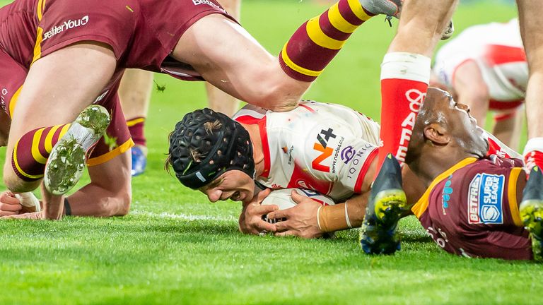 St Helens' Jonny Lomax scores a try against Huddersfield