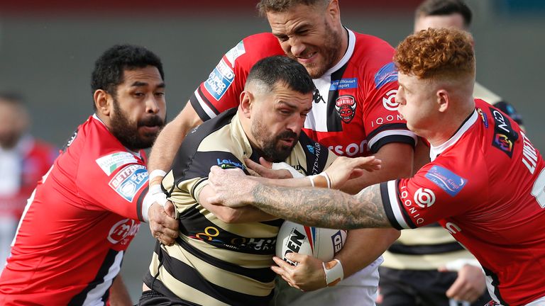 Leigh Centurions' Ben Flower in action with Salford Red Devils' Lee Mossop and Harvey Livett