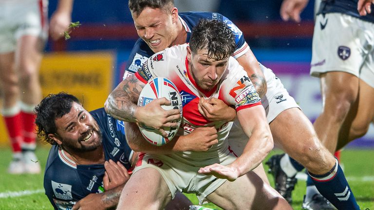 St Helens' Mark Percival is tackled by Wakefield's David Fifita and Yusuf Aydin