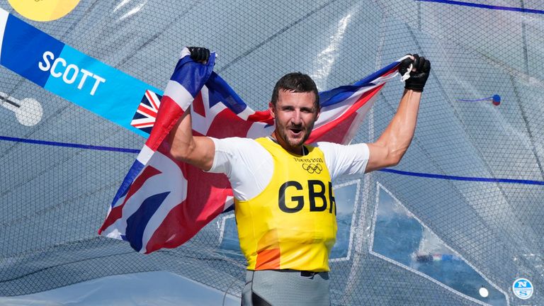 Britain's Giles Scott celebrates after placing first in the men's Finn medal race 