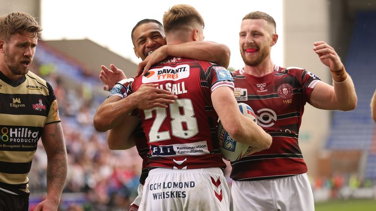 Sam Halsall celebrates his Wigan try - one of nine the Warriors notched on the day 