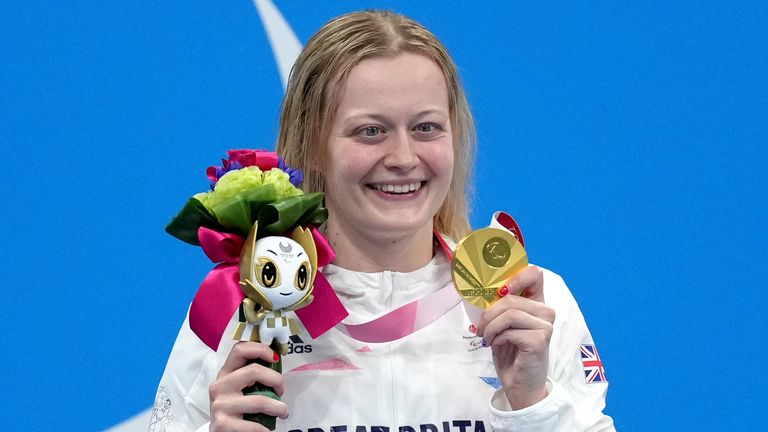 Russell celebrates on the podium after receiving her Paralympics gold medal