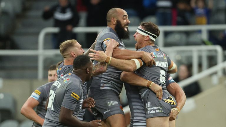 Catalans players celebrate after James Maloney's drop goal clinched victory over St Helens