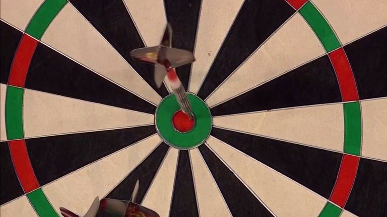 Michael Smith hits a 126 checkout on the bullseye against Gerwyn Price in their opening round match at the World Grand Prix.