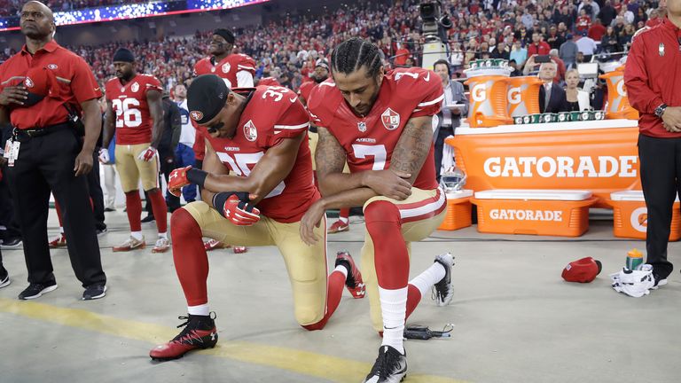 San Francisco 49ers quarterback Colin Kaepernick (right) kneels during the national anthem in September 2016