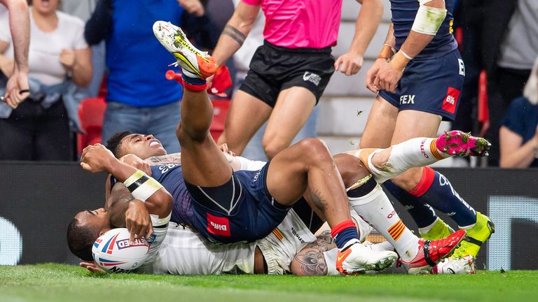 Kevin Naiqama squeezes the ball down for his first try