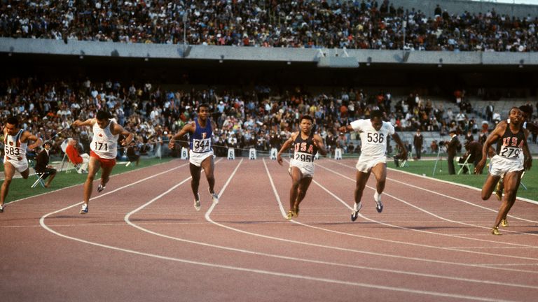 Hines (right) crosses the finish line first in the Olympics men's 100m final, with Pender (wearing 295 in the centre) finishing sixth