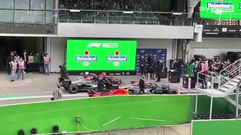 Is this the reason Max Verstappen has been summoned to stewards in Brazil? Footage appears to show the championship leader touching the rear wing of Lewis Hamilton's Mercedes in parc ferme.