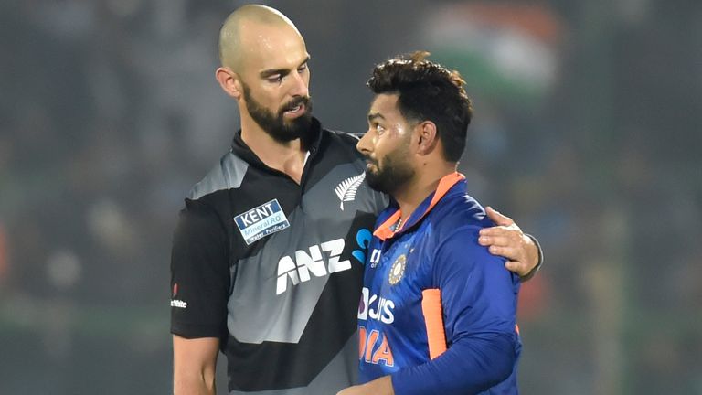 Daryl Mitchell and Rishabh Pant embrace after India's victory over New Zealand in the final over