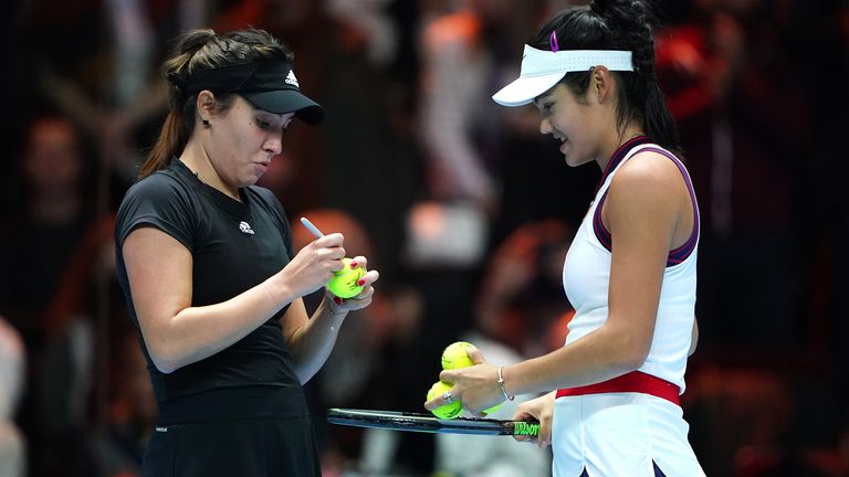 Raducanu (right) signs tennis balls with her good friend Ruse