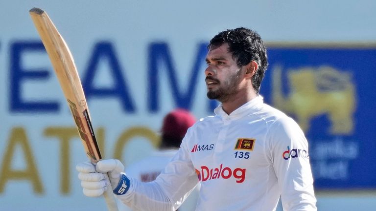 Sri Lanka's Dhananjaya de Silva raises his bat after completing his century against West Indies