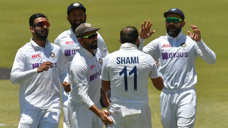 Mohammed Shami congratulates captain Virat Kohli after taking a wicket on the last day of the first test between India and South Africa