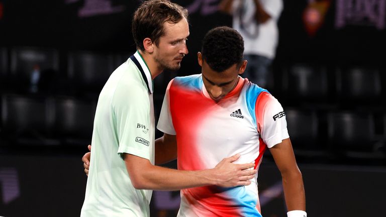 Medvedev (left) consoles Auger-Aliassime after winning their marathon clash on Rod Laver Arena