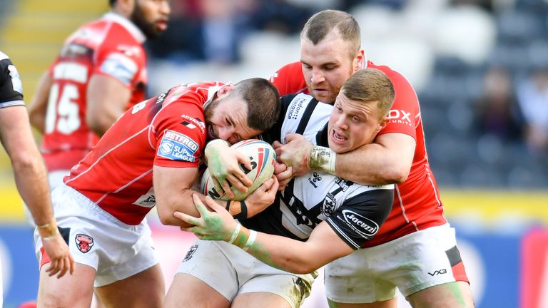 Jack Brown is tackled by Salford defenders Andy Ackers, Greg Burke and Elijah Taylor