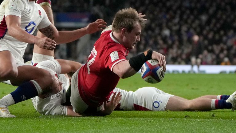 Wales' Nick Tompkins reaches out to score his side's second try in the contest 