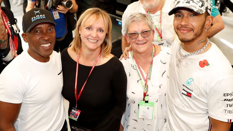 Hamilton (right) with father Anthony (far left), step mother Linda (second left) and mother Carmen