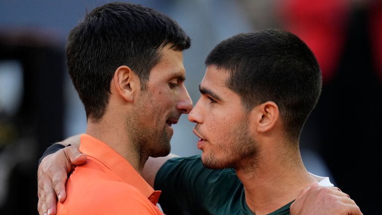 Alcaraz and Novak Djokovic (left) embrace after their Madrid Open semi-final