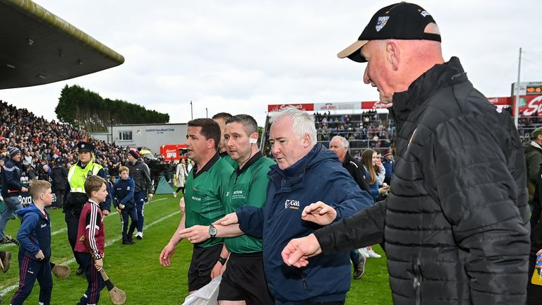 Referee Colm Lyons leaves the pitch followed by Kilkenny manager Brian Cody after full-time