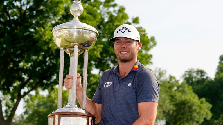 Sam Burns displays the trophy after winning the Charles Schwab Challenge in a play-off
