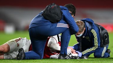 Arsenal's Rob Holding receives treatment before being substituted with a concussion in a Premier League game in February 2021