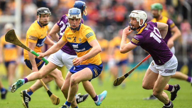 Diarmuid Ryan of Clare is chased by Oisín Foley of Wexford