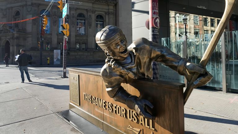 A statue depicting a female ice hockey player stands across from the Hockey Hall of Fame in Toronto (Credit: Nathan Denette)