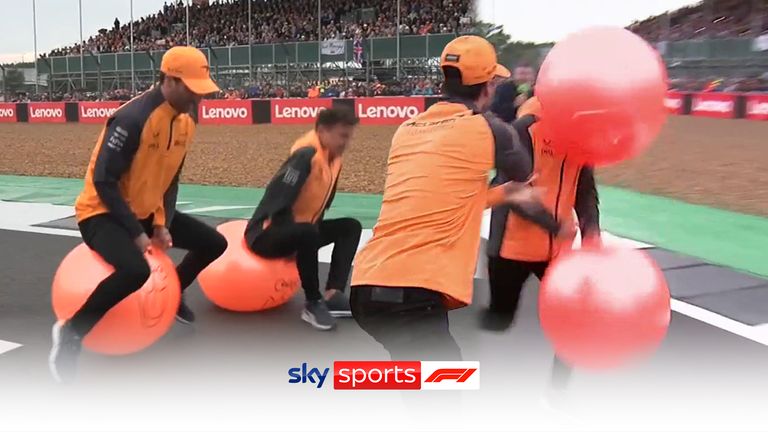 Daniel Ricciardo fouls Lando Norris as the McLaren drivers go head-to-head in a space hopper race at Silverstone.