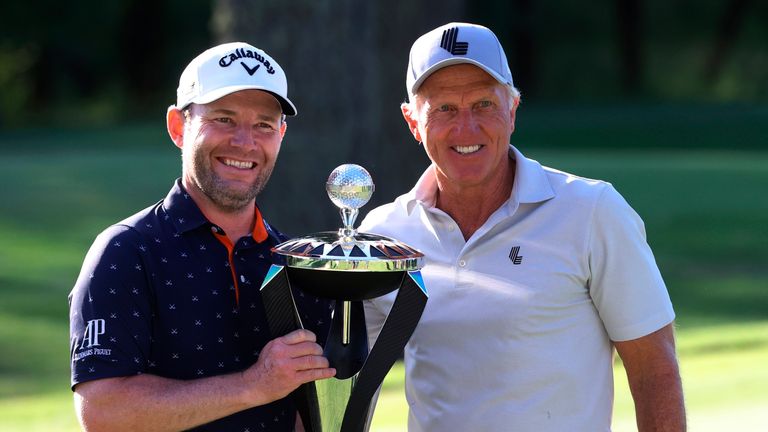 Branden Grace (L) receives his Portland Invitational trophy from LIV Golf CEO Greg Norman