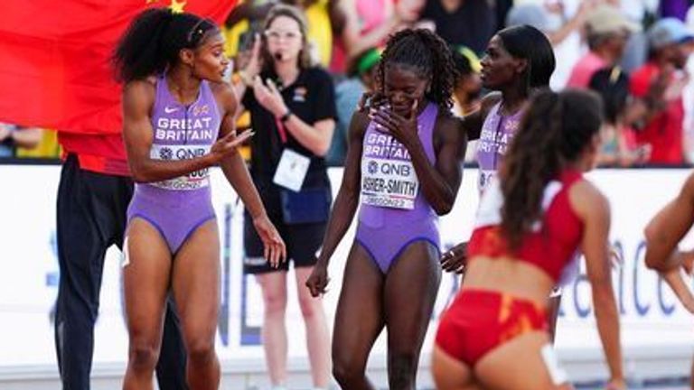 Asher-Smith's team-mates console her after the race