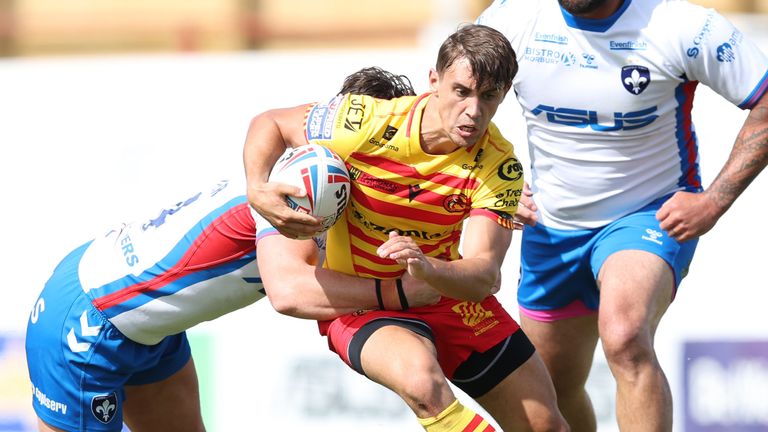 Catalans Dragons' Arthur Mourgue is held in a tackle