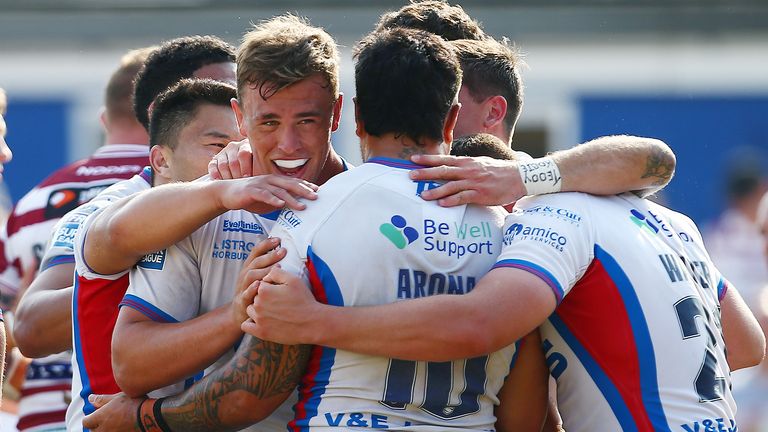 Wakefield players celebrate full-time after beating Wigan