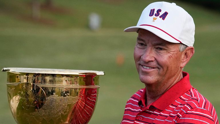 USA team captain Davis Love III holds the Presidents Cup trophy after team USA defeated the International team in match play at the Presidents Cup golf tournament at the Quail Hollow Club, Sunday, Sept. 25, 2022, in Charlotte, N.C. (AP Photo/Chris Ca